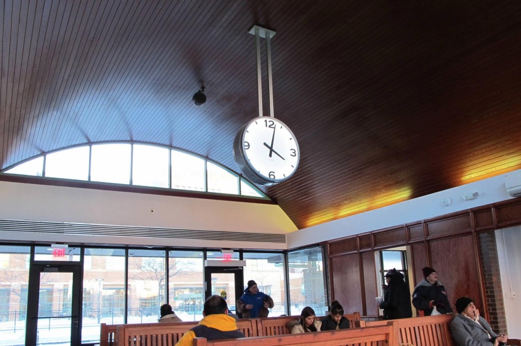 Double-faced bracket suspended station lobby clock illuminated automatic GPS 36-inch by Lumichron. Des Plaines train station, IL