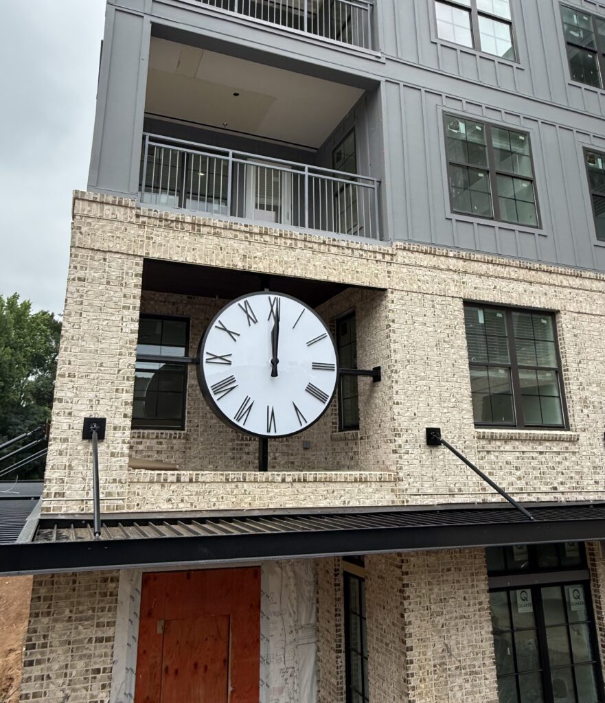 Canister Clock in a brick and sided apartment building