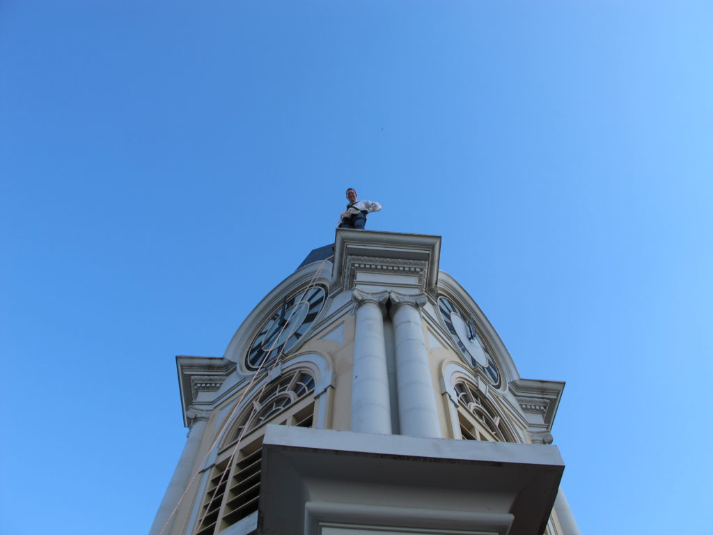 Person on top of clock tower at Oconto County Courthouse