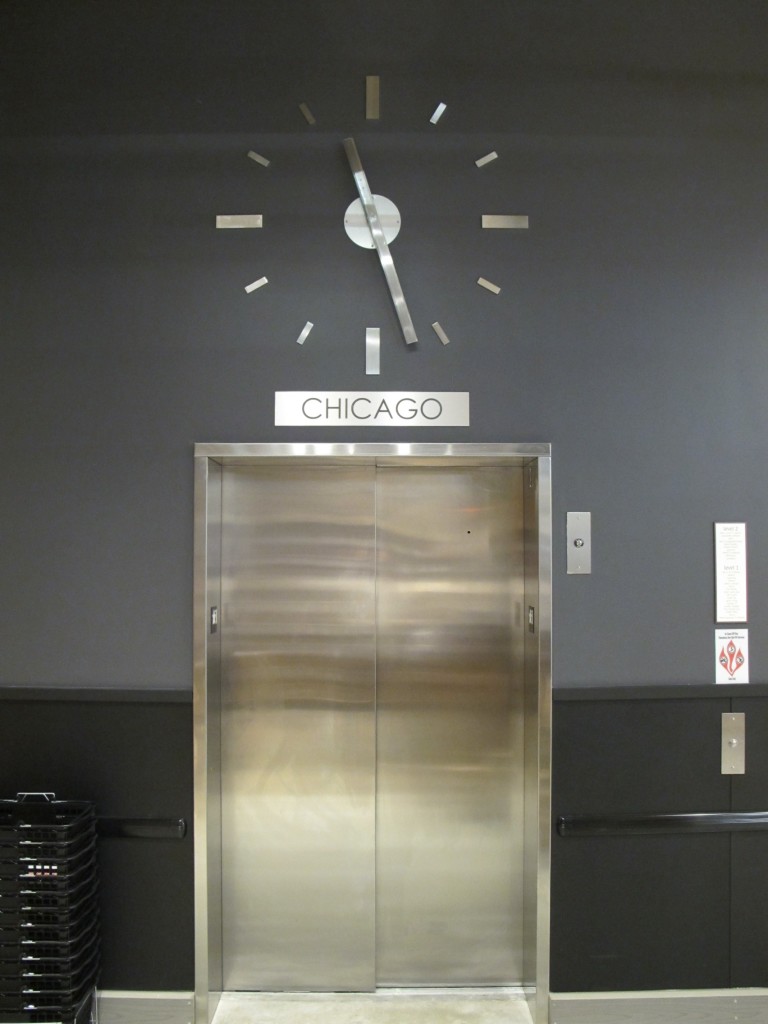 Skeletal marker silhouette elevator clock by Lumichron