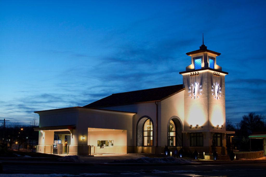 Dusk at a Bank with a pair of halo-lit Skeletal marker silhouette 108-inch Clocks by Lumichron