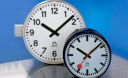 Two MOBATIME Clocks in front of a blue background