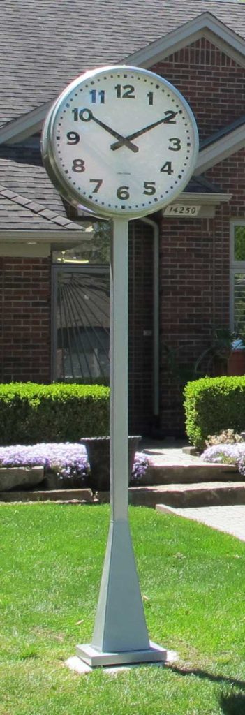 Silver Modern post streetscape clock installed on the front lawn of a residence