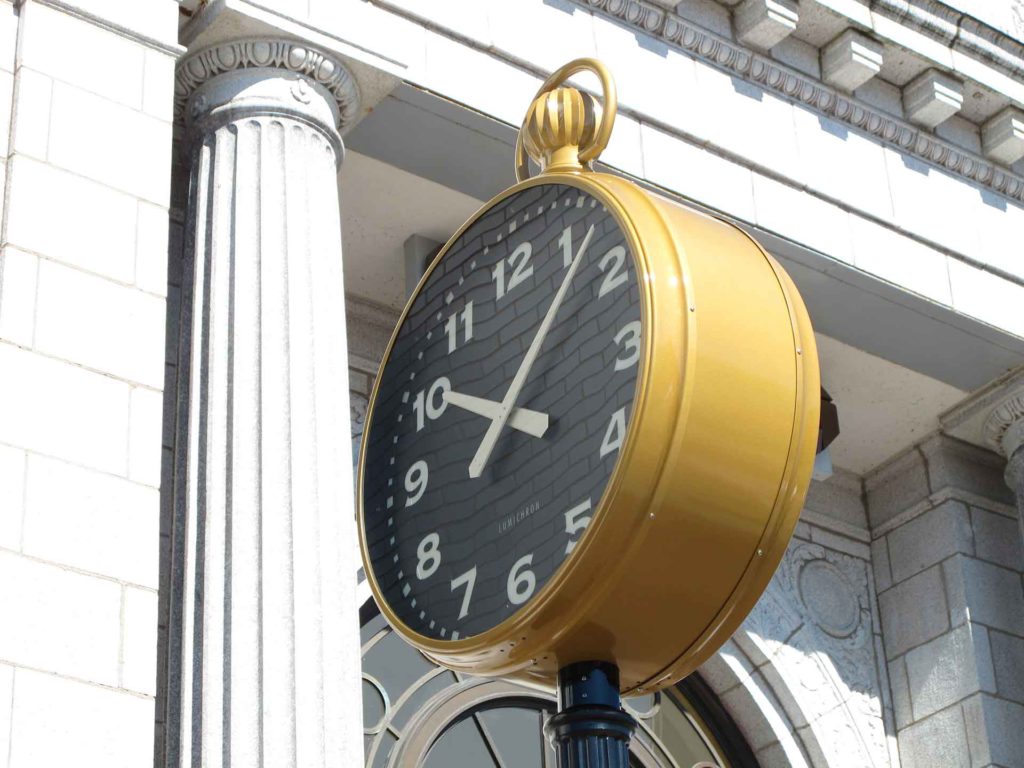 Downtown bank building wth a Post Street Streetscape clock 30-inch with gold watch winder crown illuminated fully automatic by Lumichron