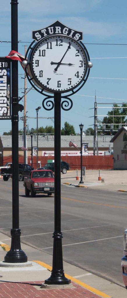 Downtown Sturgis SD with a black and silver Post Street Streetscape clock 36-inch custom illuminated fully automatic by Lumichron