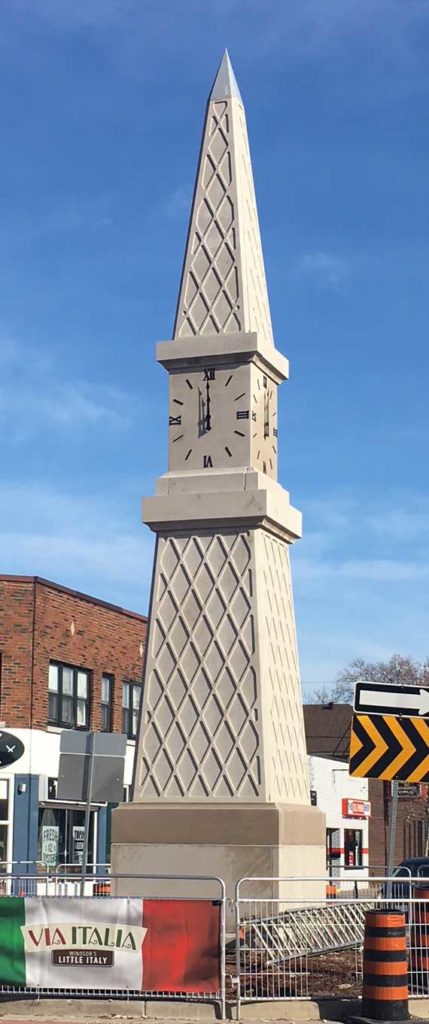 Traffic circle with a monument and 4 skeletal silhouette marker clocks with 36-inch Roman dials by Lumichron