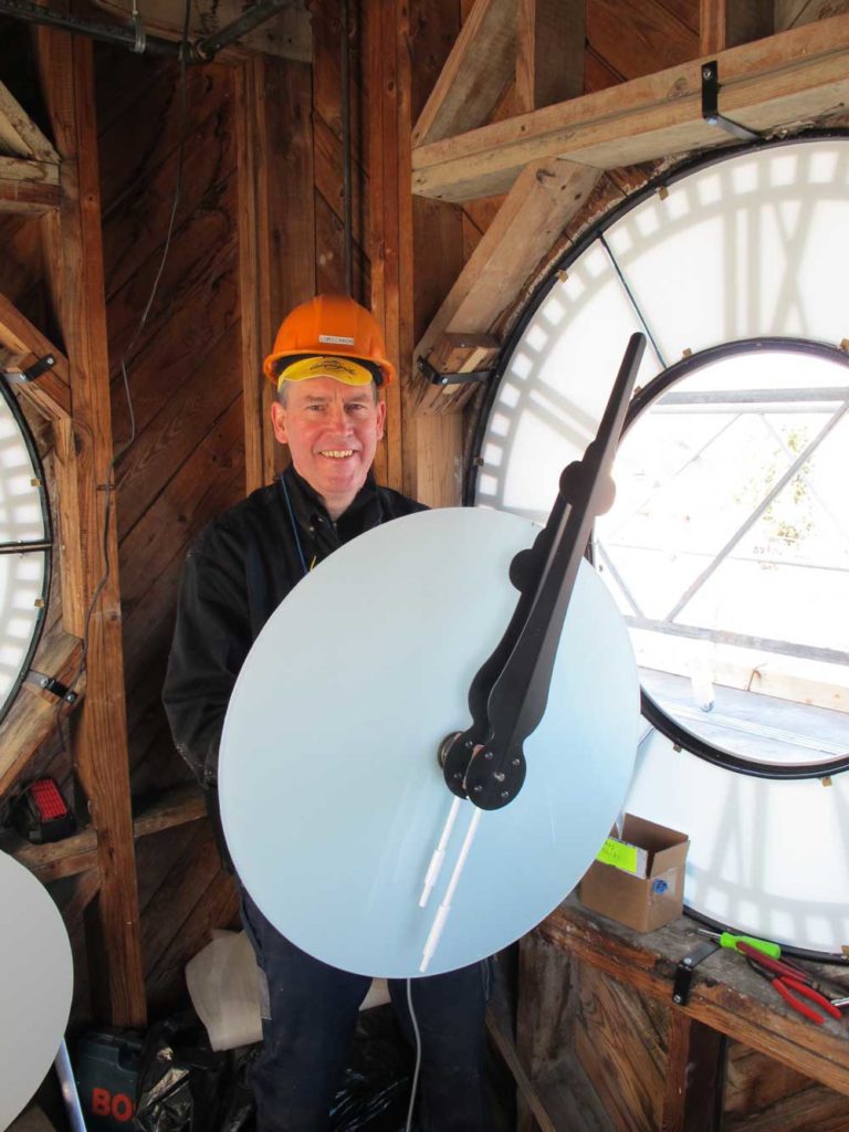 Installing a new clock dial from the inside of a clock tower
