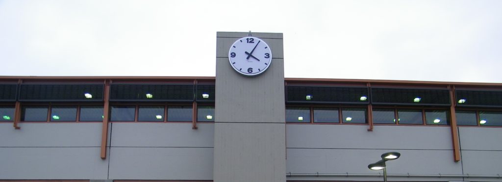 72-inch diameter Surface Mount Tower Clock by Lumichron, installed at the Bay Area Transit Pleasantville Station, San Francisco California. Clock face with a 12, 3, 6, 9 vacuuformed embossed polycarbonate, illuminated