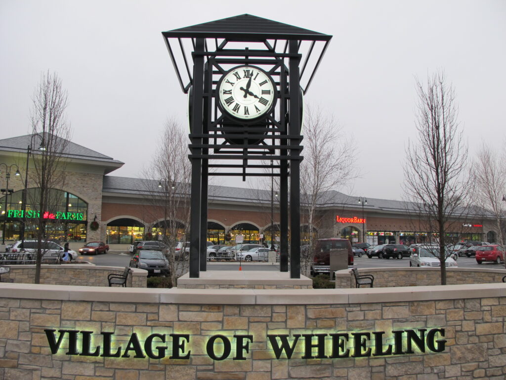 Village of Wheeling, Illinois, Icon Shelter - Lumichron Clock tower with a set of a4, 48-inch diameter Roman Clocks illuminated fully automatic GPS
