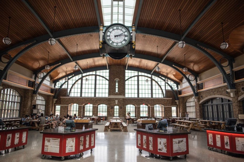 Four-sided enclosed custom clock suspended in train station